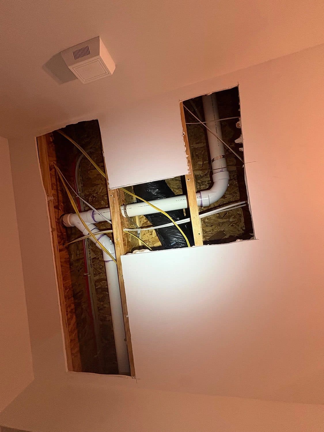 Ceiling opened up to run new water lines during a home repipe