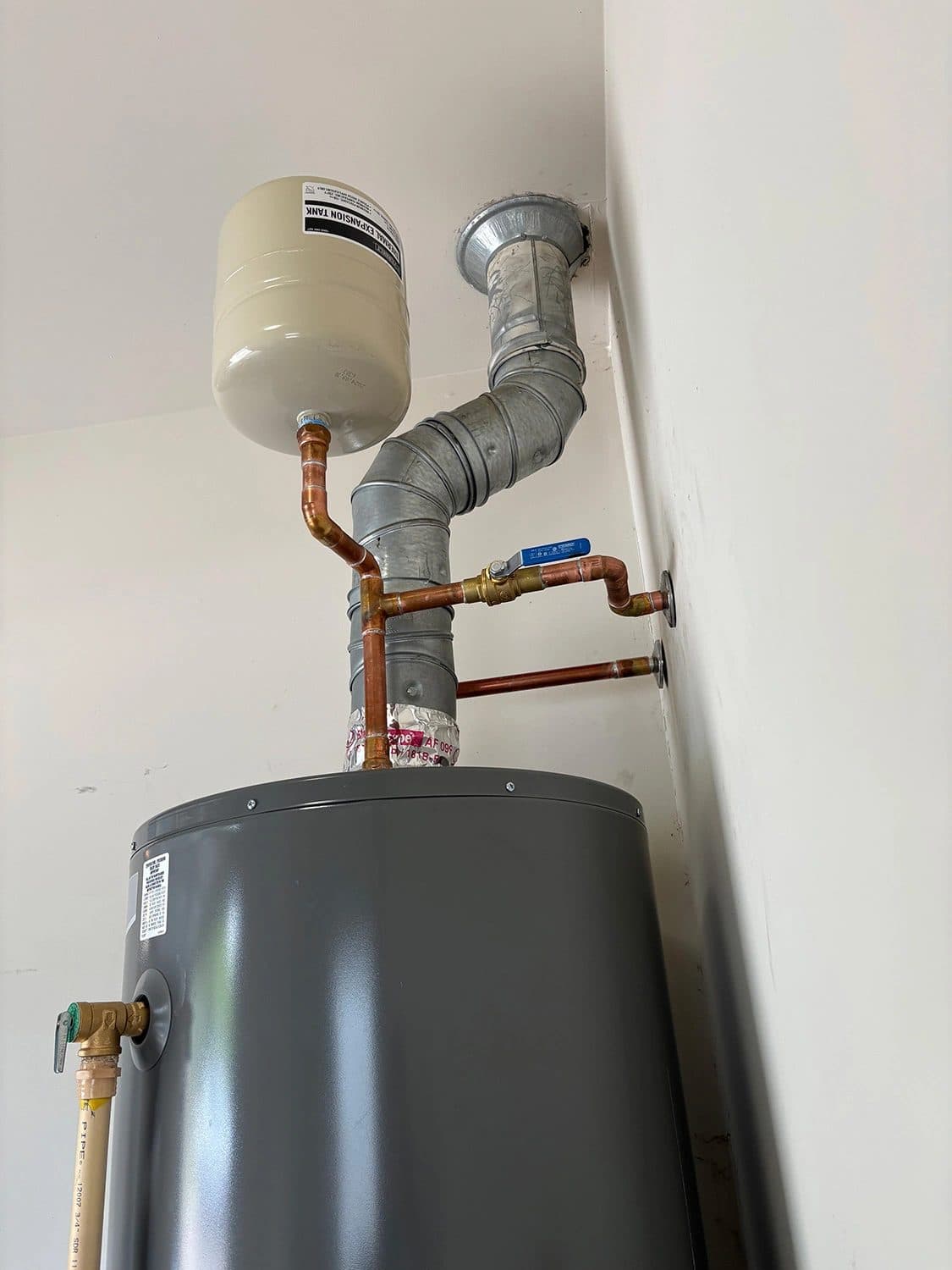 New tank water heater installed with an expansion tank and fresh supply piping in Murfreesboro