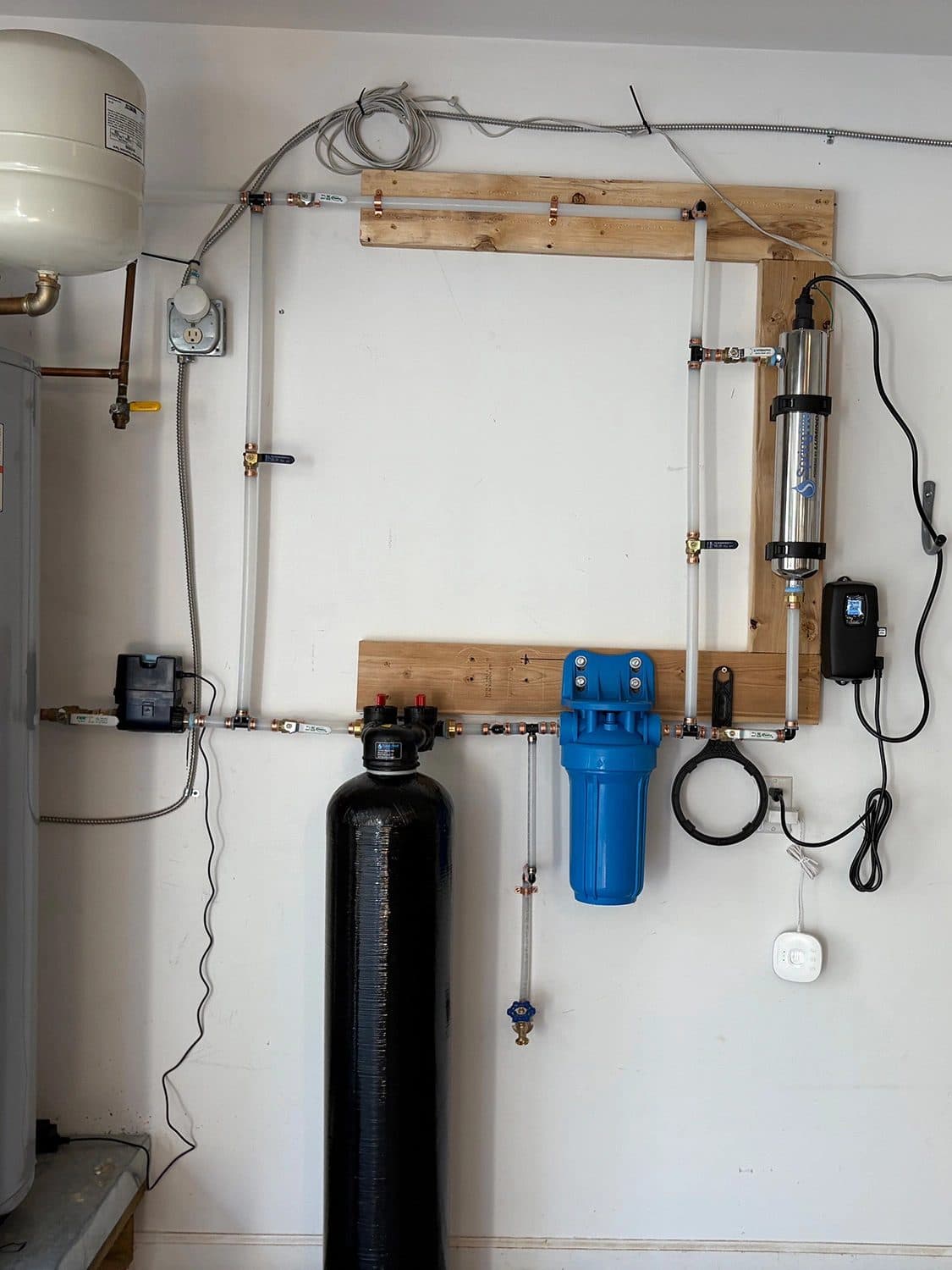 Whole-house water softener and filtration system installed in a garage